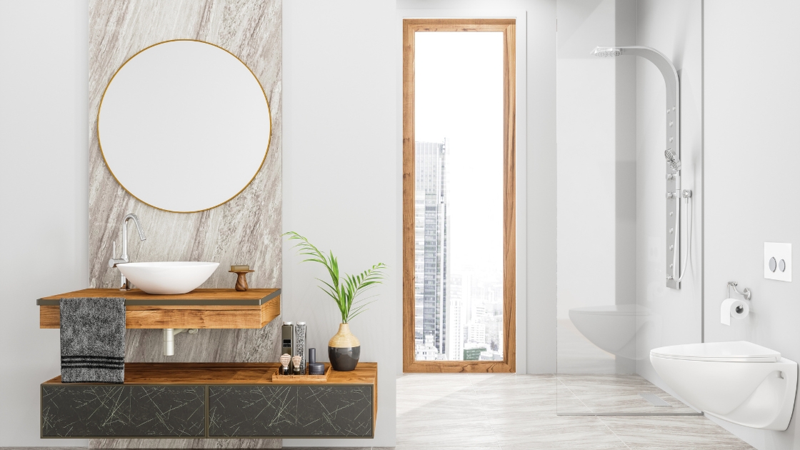 Modern bathroom interior with minimalist design elements, featuring a sleek vanity with a vessel sink installed by a professional plumber, circular mirror, and a view of the cityscape through the adjacent glass door.